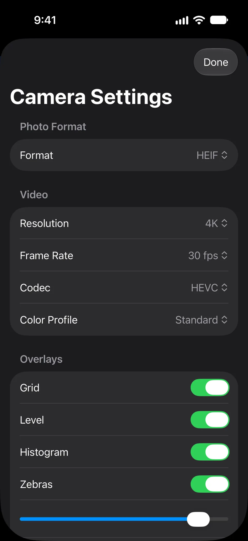 The Camera Settings sheet on an iPhone: photo format (HEIF here), video at 4K, 30 fps and HEVC with a color profile setting, and the Grid, Level, Histogram and Zebras overlays.