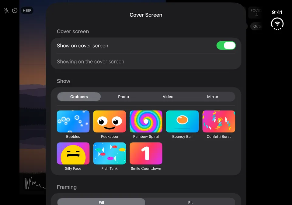 The Cover Screen sheet on the inner screen: a Show on cover screen switch, tabs for Grabbers, Photo, Video and Mirror, and the eight animation tiles.